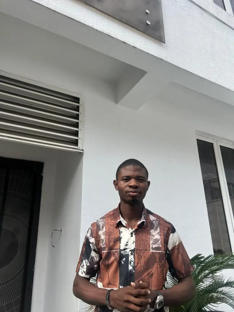 Olaitan Adebayo outdoors in a patterned shirt